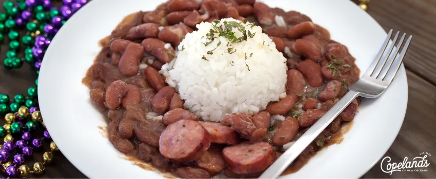 COD- A plate of New Orleans red beans and rice on a wooden table