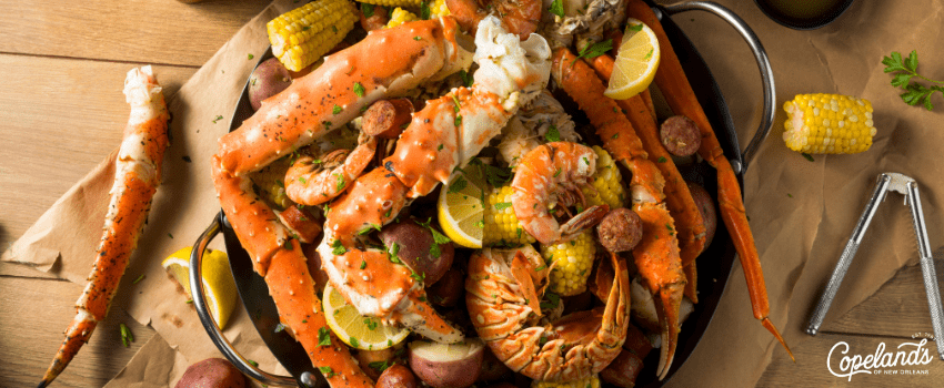 COJ - A bowl of homemade Cajun seafood boil on a wooden table