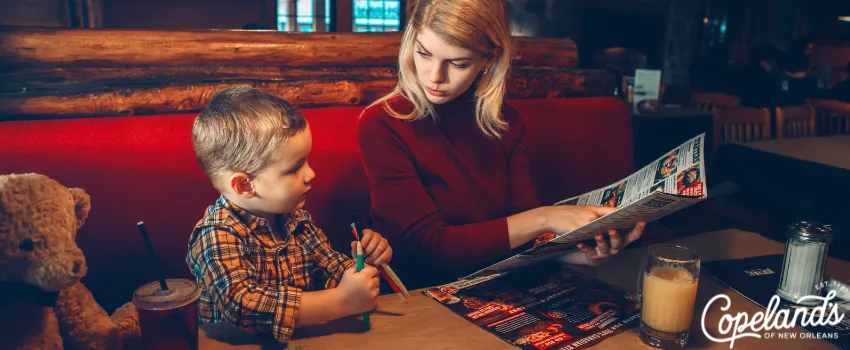 JDC - A mother and son browsing a restaurant menu